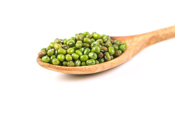close up green mung beans in wooden spoon on white background