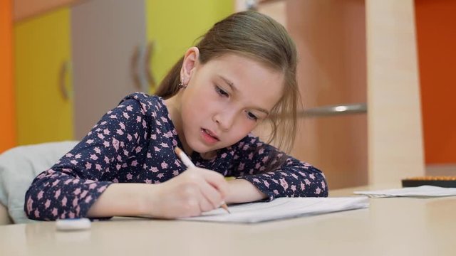 A girl of 8 years of age studies at home on mental arithmetic