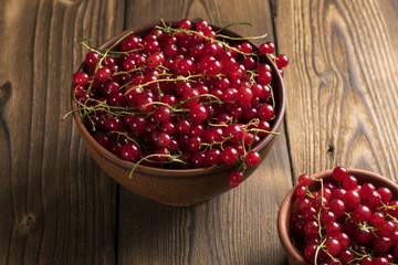 Red currant on brown wooden table