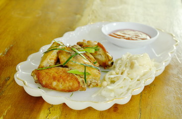 fried chicken wing with slice cabbage dipping chili sauce on plate