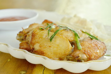 fried chicken wing salt and pepper topping slice lemon grass with slice cabbage on plate