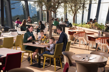 Young parents enjoying lunch time with their children