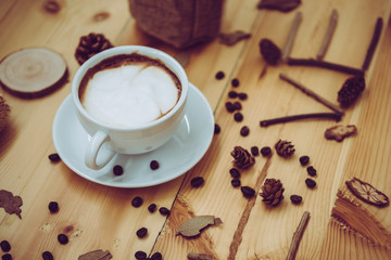 cup of coffee on old wooden desk. Simple workspace or coffee break in morning/ selective focus