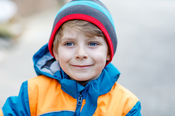 Outdoor fashion portrait of adorable little kid boy wearing colorful clothes