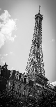 Eiffel tower and typical parisian house with mansards. Black and white. Vignette.