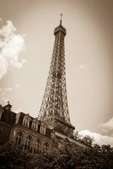 Eiffel tower and typical parisian house with mansards. Sepia. Vignette.