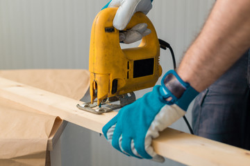 Carpenter handyman using electric handy saw