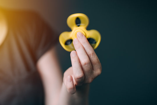 Woman playing with fidget spinner