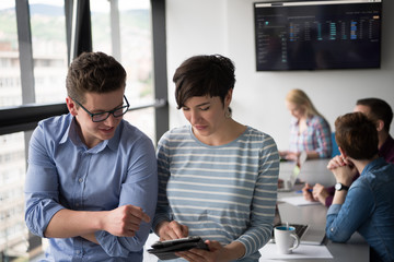 Two Business People Working With Tablet in office