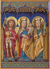 BERLIN, GERMANY, FEBRUARY - 16, 2017: The carved polychrome gothic altar with the Madonna, St. Barbara and St. George in  Dominicans church of St. Pauls by unknown artist of 15. cent.