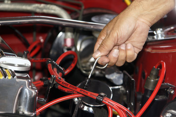 Mechanic checking mototr oil level in a car engine