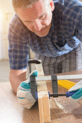 Man using bar clamp in a warkshop