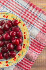cherries on the table in plate red napkin