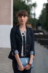 Business lady in a business suit with a small bag.