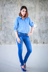 Asian woman casual outfits standing in jeans and blue denim shirt, women brown hair and short hair, beauty and fashion jeans concept