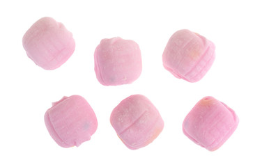 Several pink dinner mint candies isolated on a white background.