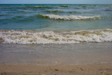 The turquoise sea waves on a summer day