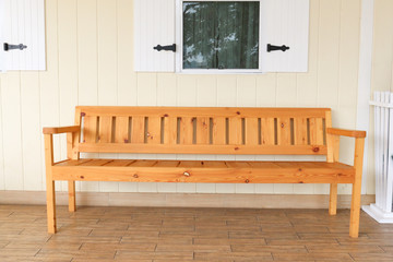 wooden bench on house patio in summer