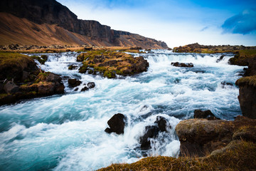 Stormy mountain river in the severe stony deserted landscape of Iceland. Toned