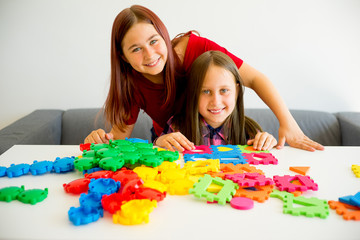 Two girls playing with construction blocks
