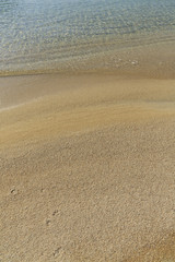 Soft sea wave on sandy beach, Beautiful Greek beach with fine sand, Close up photo of sandy beach with soft wave in motion
