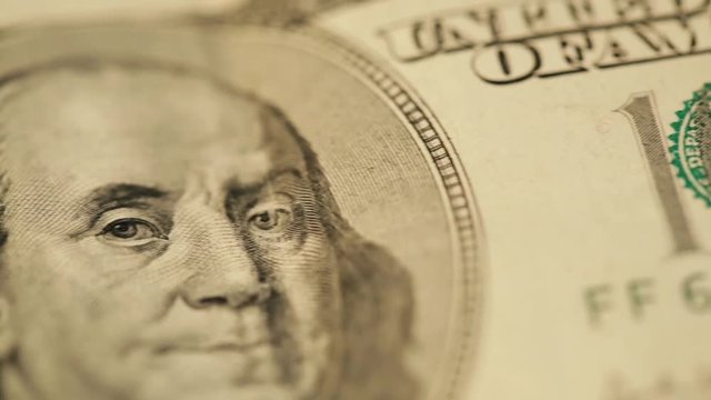 Cash money background. Benjamin Franklin portrait on 100 US dollar bill close up