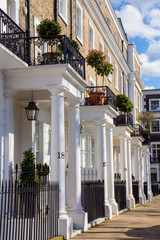 Row of beautiful white edwardian houses in Kensington, London