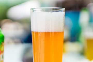 Close up of a glass of fresh, ice-cold beer - grapefruit. A refreshing drink in the hot summer days on the beech. Concept holiday, summer lasy days. Shallow depth of focus, bokeh background.