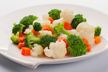 Vegetable mix with carrot, broccoli and cauliflower. On white plate