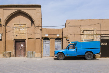blue old car in front of the wall, Iran