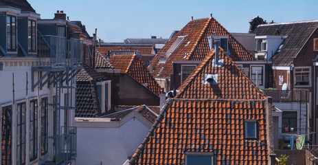 Old traditional Dutch city rooftops on a clear blue sky. Leiden, The Netherlands