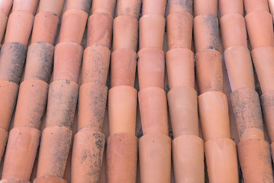 Red roof tiles or shingles on house as background image.