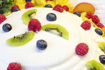 Cheese mousse with several piece of fruits such as berries, cranberries, pinneaple, kiwi