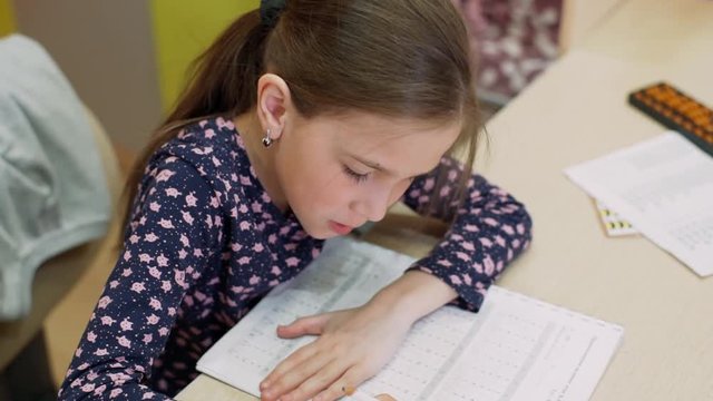 A girl of 8 years of age studies at home on mental arithmetic