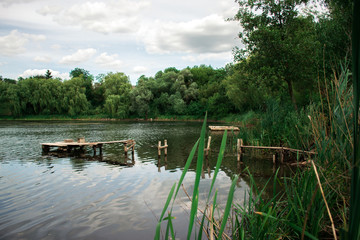 Fototapeta premium Summer day landscape on a pond in the village.