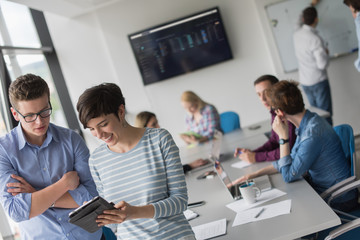 Obraz premium Two Business People Working With Tablet in office