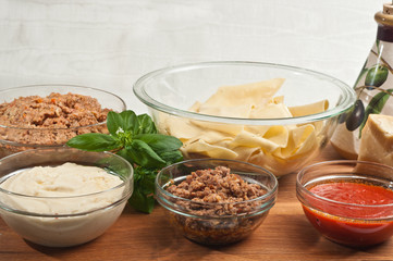 Artisan, homemade lasagna organic ingredients on a wood cutting board