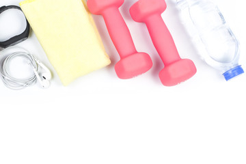 sport, healthy lifestyle and objects concept - close up of dumbbells, fitness tracker, earphones and water bottle over white background