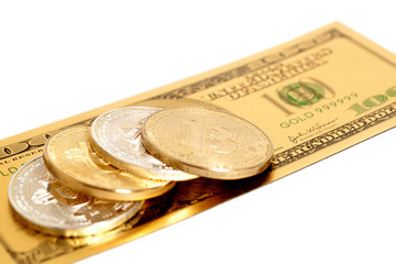 Golden end silver bitcoins  with U.S. dollar isolated on white