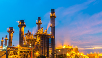 Oil refinery plant at twilight with sky background