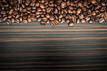 Coffee beans concept on wooden table background.