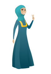 Muslim business woman showing victory gesture.