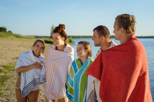 Group of colorful young people wrapped in towels
