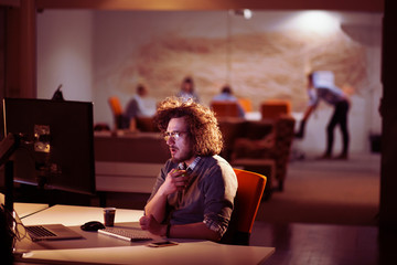 man working on computer in dark office