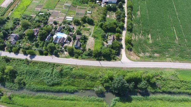 A flight from a bird's-eye view over the Russian village in the Kuban. Countryside, houses and gardens.