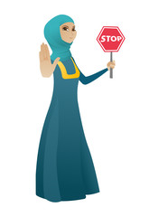 Muslim business woman holding stop road sign.