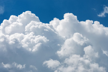 Fototapeta na wymiar White fluffy big clouds against blue sky