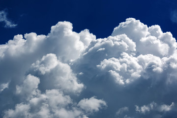Naklejka na ściany i meble White fluffy big clouds against blue sky