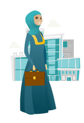 Muslim business woman holding briefcase.