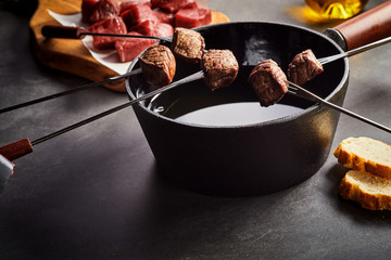 Fondue Forks of Cooked Beef with Pot of Hot Oil